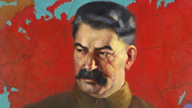 A painting of Stalin in front of a map of the Soviet Union